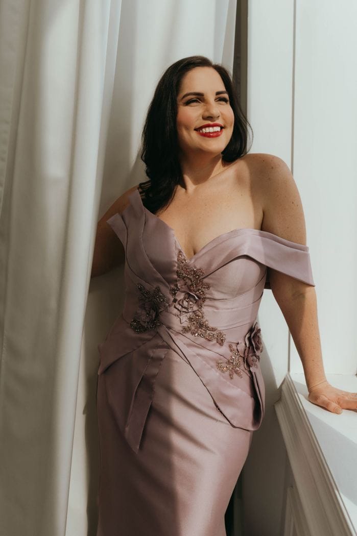 Stephanie smiling in a blush evening gown